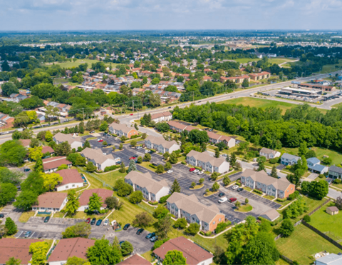 A bird's eye view of a residential area with houses and greenery.