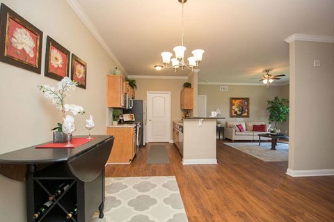 A living room with a dining table and chairs.