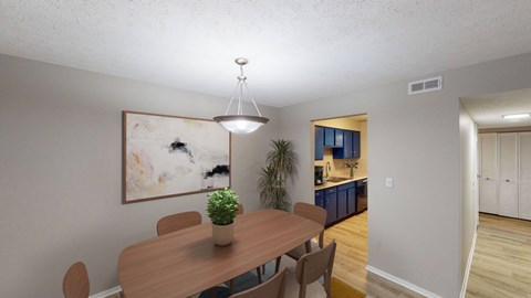 A dining room with a wooden table and chairs.