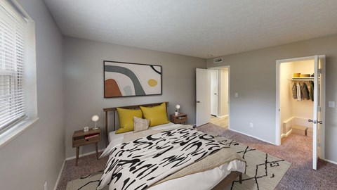 A bedroom with a large bed and a painting on the wall.