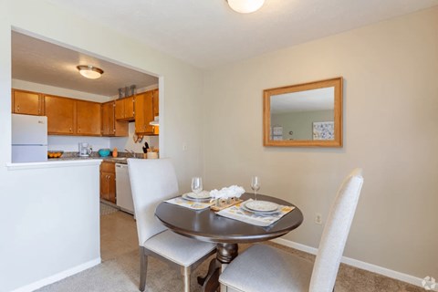 A dining room with a table set for two.