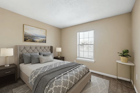 A bedroom with a large bed and a painting on the wall.