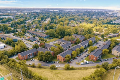A bird's eye view of a residential area with houses and cars.