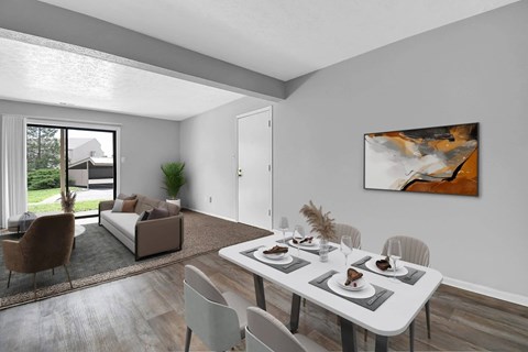 A modern dining room with a white table and chairs.