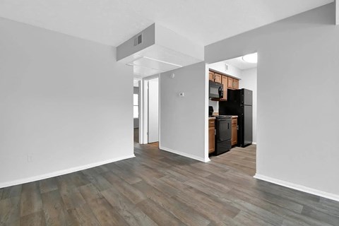 A kitchen area with a refrigerator, oven, and microwave.