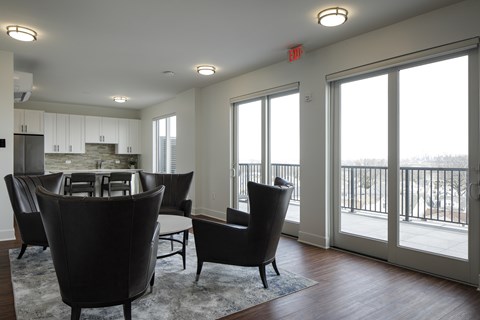 A living room with a black chair and a table.