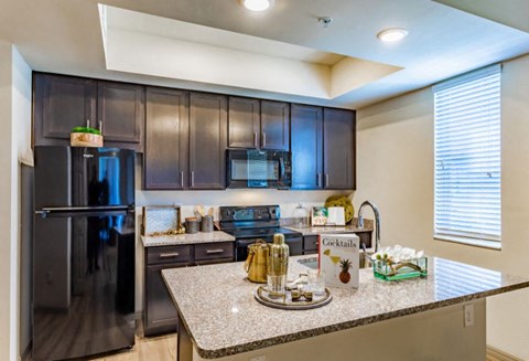a kitchen with stainless steel appliances and granite counter tops