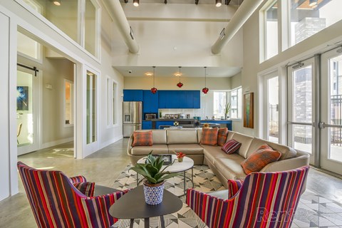 A living room with a couch, chairs, and a coffee table.