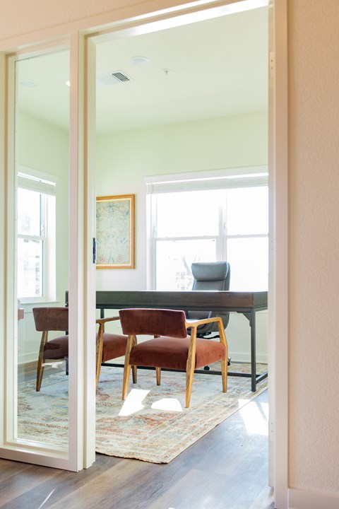 A room with a table and chairs is visible through an open door.
