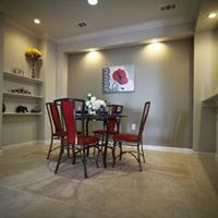 A dining room with a table set for two.