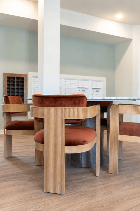 A dining room with a table and chairs.