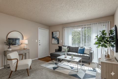 A living room with a grey couch, a white chair, and a coffee table.