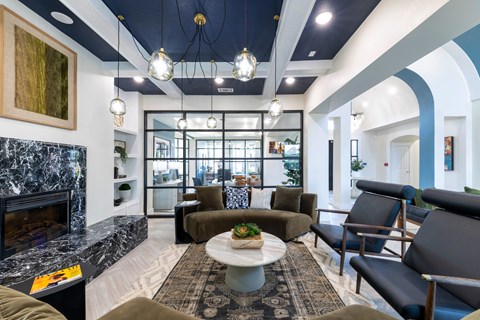 A modern living room with a fireplace and comfortable seating.