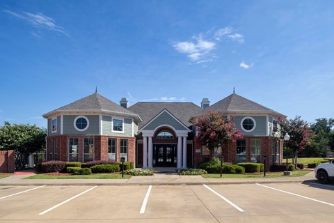 A building with a parking lot in front of it.