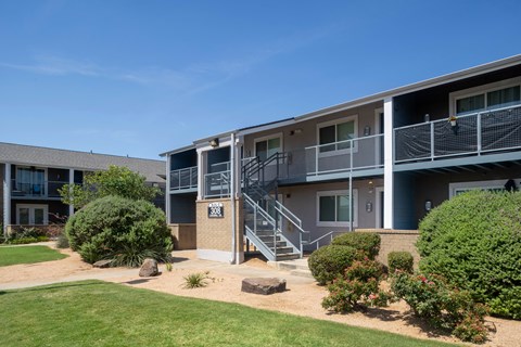 Apartment complex with a clear blue sky above.