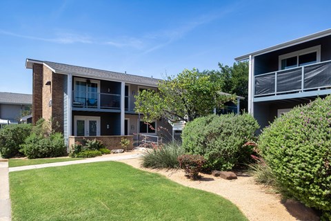 A modern building with a green lawn in front.