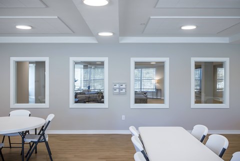 A conference room with a white table and chairs.
