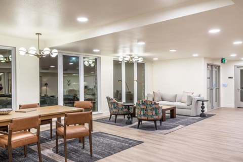 A modern dining room with a wooden table and chairs.