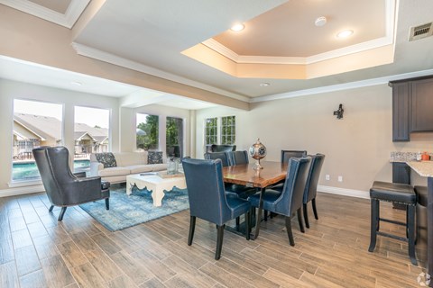 A dining room with a table and chairs.