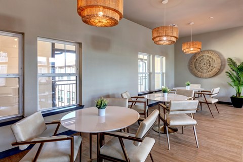 A dining room with a round table and chairs.