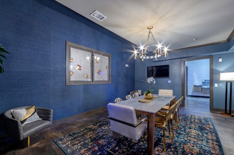 A dining room with a wooden table and chairs.