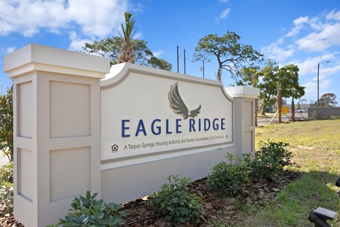 A sign for Eagle Ridge reads "A Tarpon Springs Housing Authority and Town of Tarpon Springs".