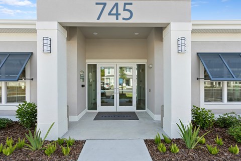 The image shows the front of a building with the number 745 on it.