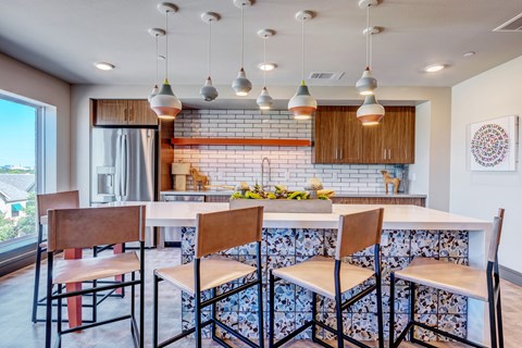 A kitchen with a table and chairs.