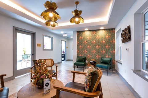 A living room with a floral wallpaper and a wooden table.
