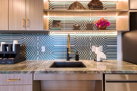 A kitchen with a sink and a coffee maker.