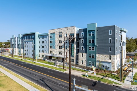 A street view of a row of modern apartment buildings.