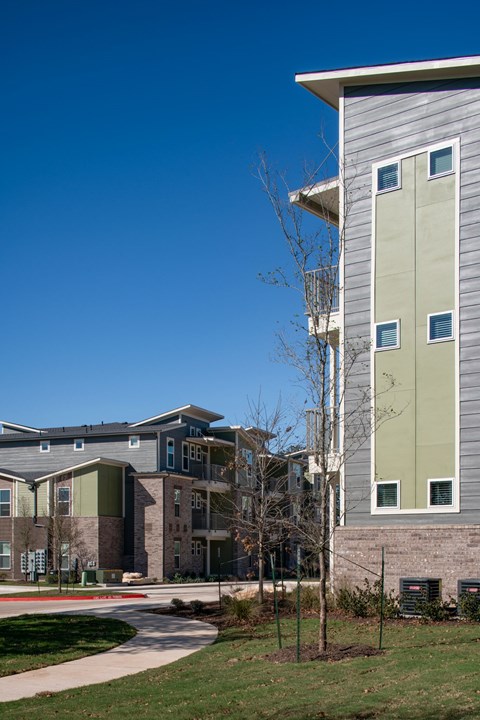 A modern building with a grey and green facade.