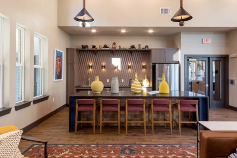 A dining area with a long table and chairs.