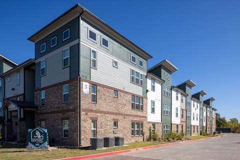 A row of apartment buildings with a sign that says "Neighborhood".