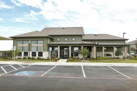 A building with a parking lot in front of it.