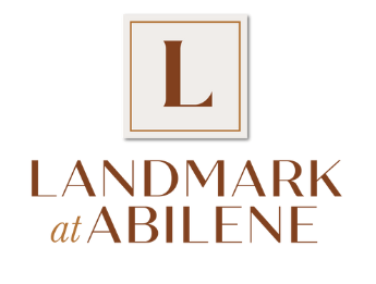 A brown and white logo with the words Landmark at Abilene.