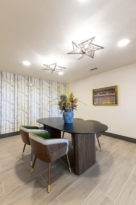 A dining room with a round table and chairs.