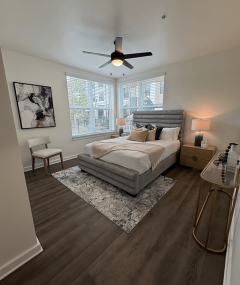 A bedroom with a large bed and a ceiling fan.
