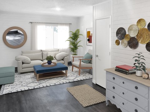 A living room with a white couch, a blue coffee table, and a mirror on the wall.