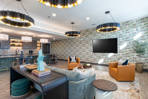 A modern living room with a brick wall and a flat screen TV.