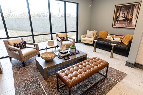 A living room with a large window and a view of a field.
