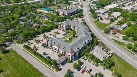 A large building with a parking lot in front of it.