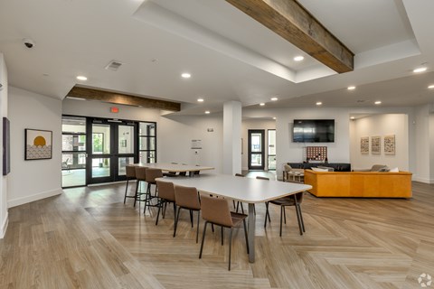 A conference room with a long table and chairs.