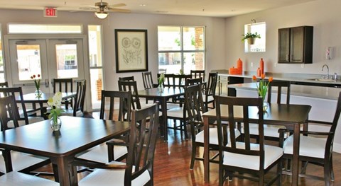 A dining room with a table and chairs.