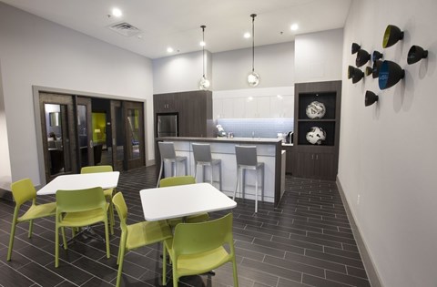 A modern kitchen with a dining table and chairs.