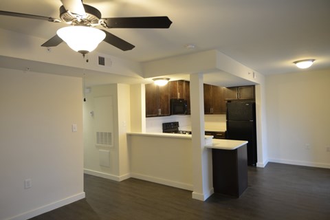 A kitchen with a black refrigerator and a white island.