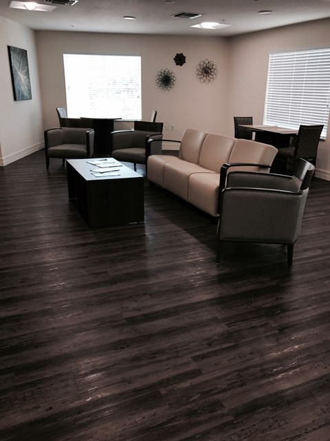 A living room with a couch, chairs, and a coffee table.