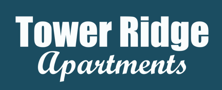 A sign that says "Tower Ridge Apartments" in white text on a blue background.