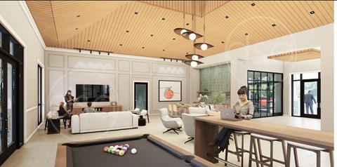 A woman is sitting at a desk in a modern room with a pool table.