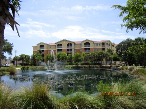 A building with a fountain in front of it.